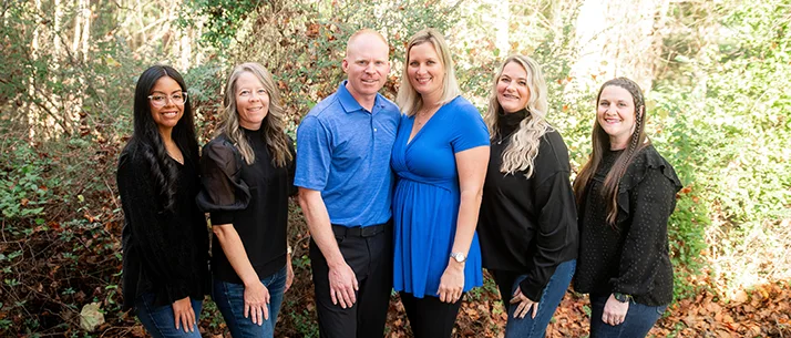 Matthew Liles And Beth Liles With Team outside.